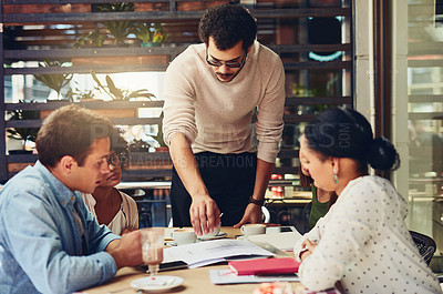 Buy stock photo Cropped shot of designers having a meeting at a coffee shop