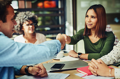 Buy stock photo Cropped shot of designers shaking hands at a coffee shop