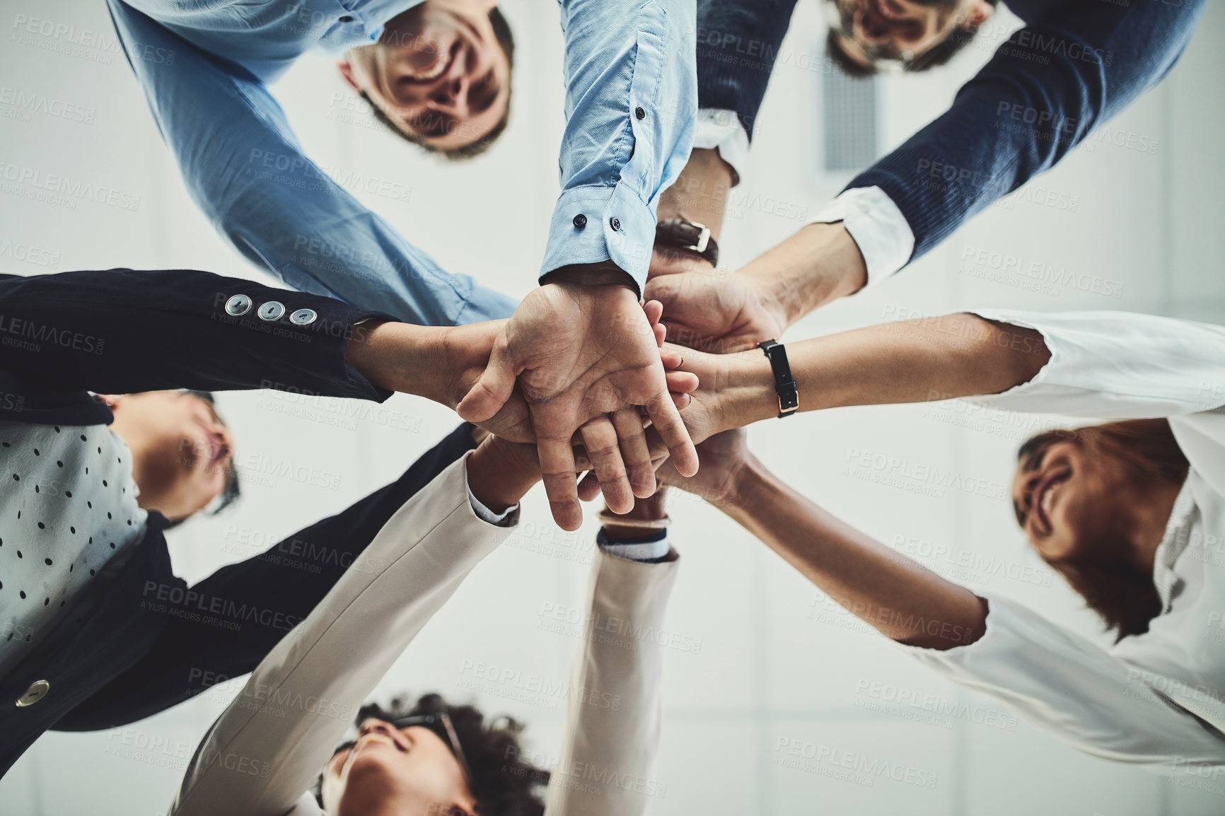 Buy stock photo Team of business people hands stacked showing teamwork, collaboration and standing united for project development and innovation. Group of corporate colleagues joining in support and unity from below