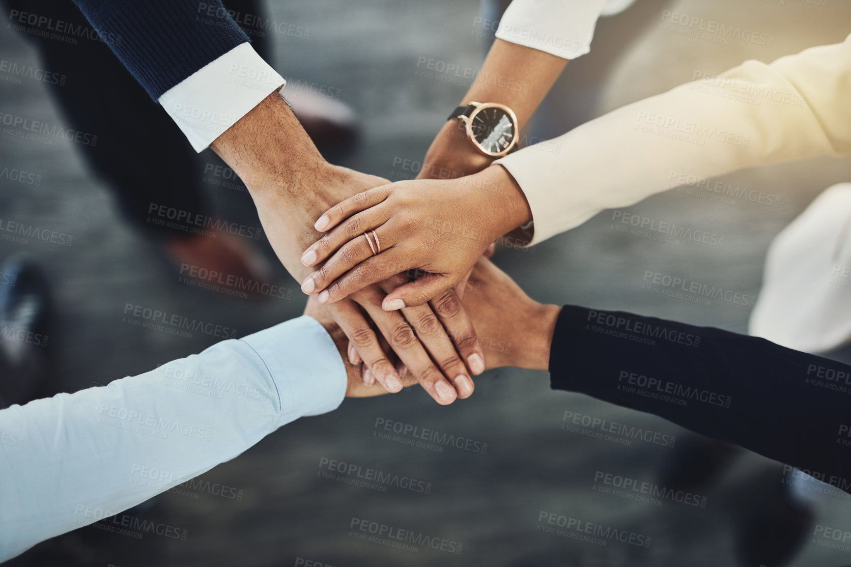 Buy stock photo Hands stacked or piled to show team unity, strength or motivation among business men, women or colleagues from above. Closeup of huddled, motivated group of businesspeople in support and trust circle