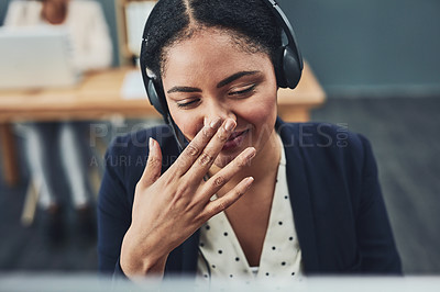Buy stock photo Young call centre agent covers their mouth to hide their smile. The client makes the employee happy with their positive feedback or joke. Building a professional and friendly relationship online.
