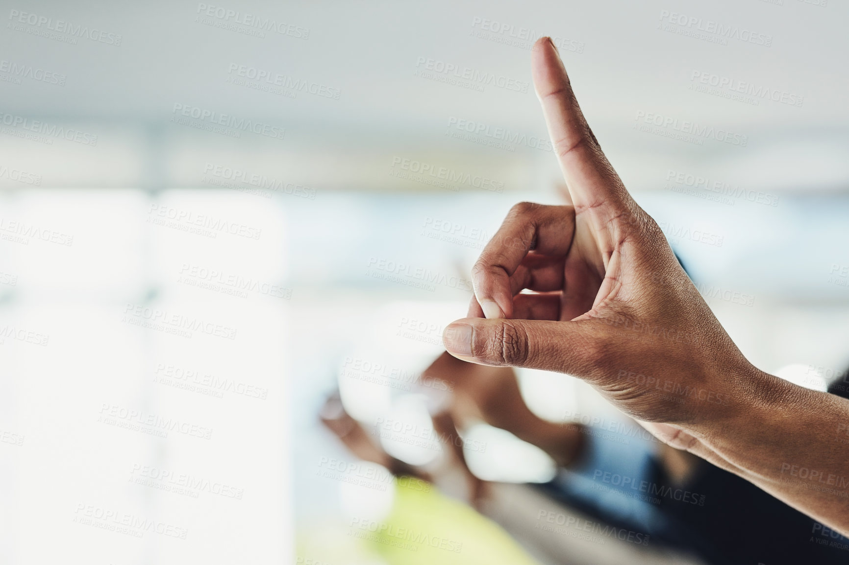Buy stock photo Raising hand and finger to ask a business question in a modern office. Closeup of group of colleagues with raised fingers at a conference meeting or seminar with bright ideas over copy space.