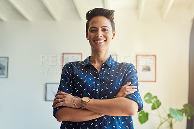 Buy stock photo Cropped portrait of an attractive young female designer standing with her arms folded in the office