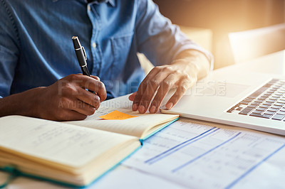 Buy stock photo Cropped shot of an unrecognizable male designer taking notes while working in his office