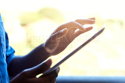 Buy stock photo Cropped shot of an unrecognizable male designer working on a tablet in his office