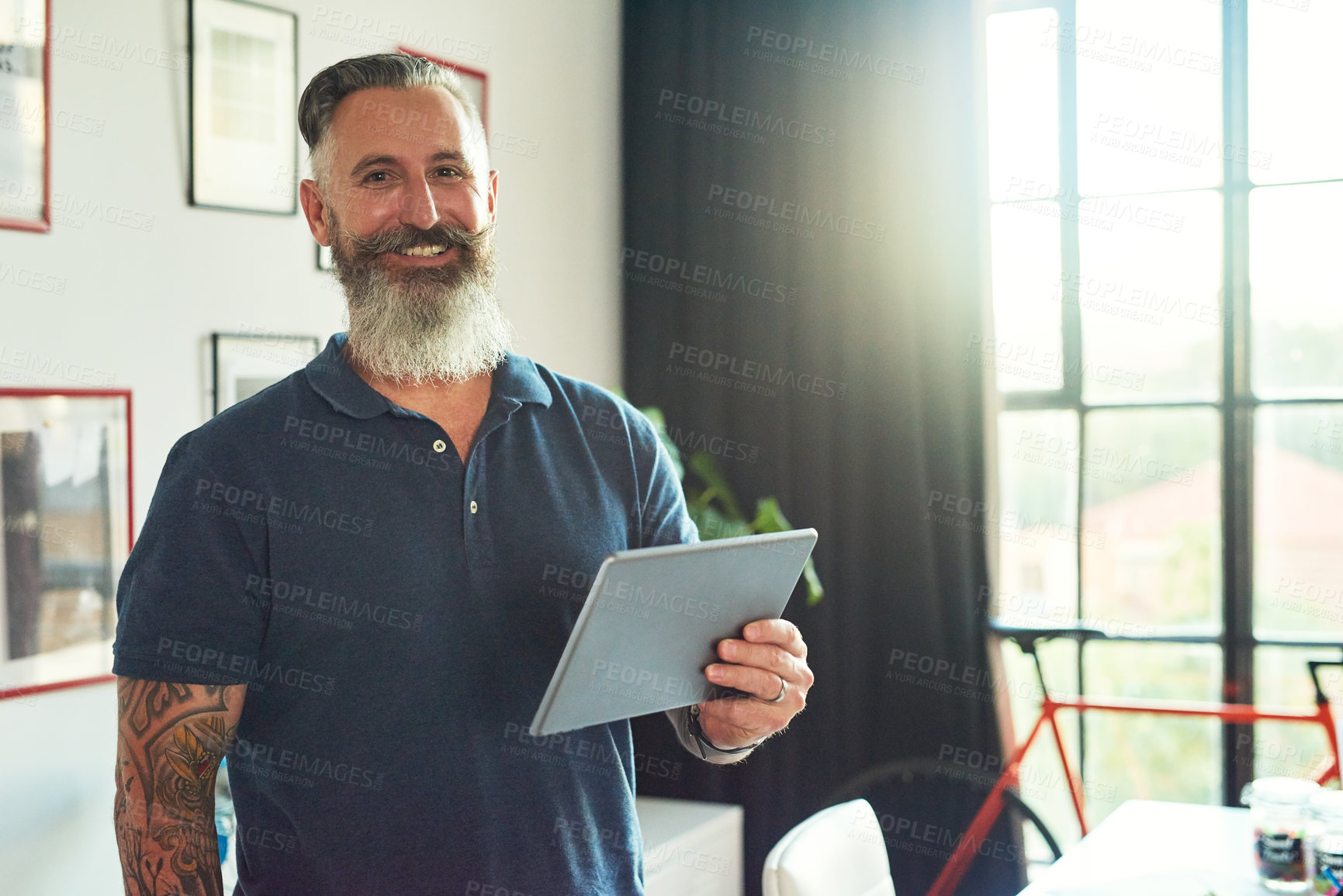 Buy stock photo Cropped portrait of a handsome mature male designer working on a tablet in his office