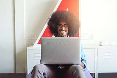 Buy stock photo Cropped shot of a young creative employee using a laptop in a modern office