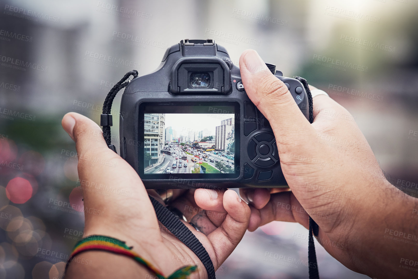 Buy stock photo Shot of an unrecognizable man taking pictures with a camera in the city