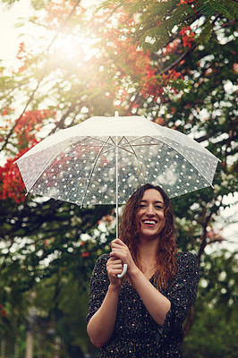 Buy stock photo Cropped shot of a beautiful young woman walking in the rain outside