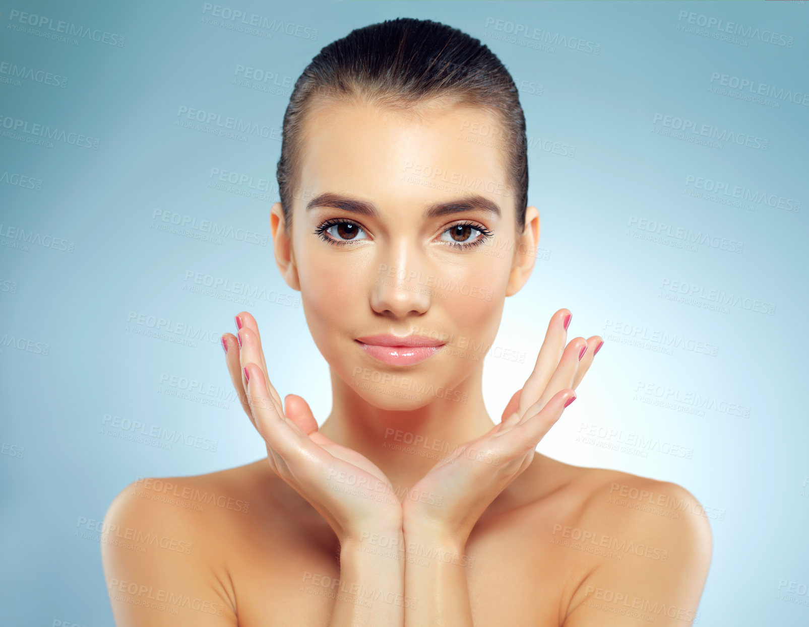 Buy stock photo Studio portrait of a beautiful young woman posing against a blue background