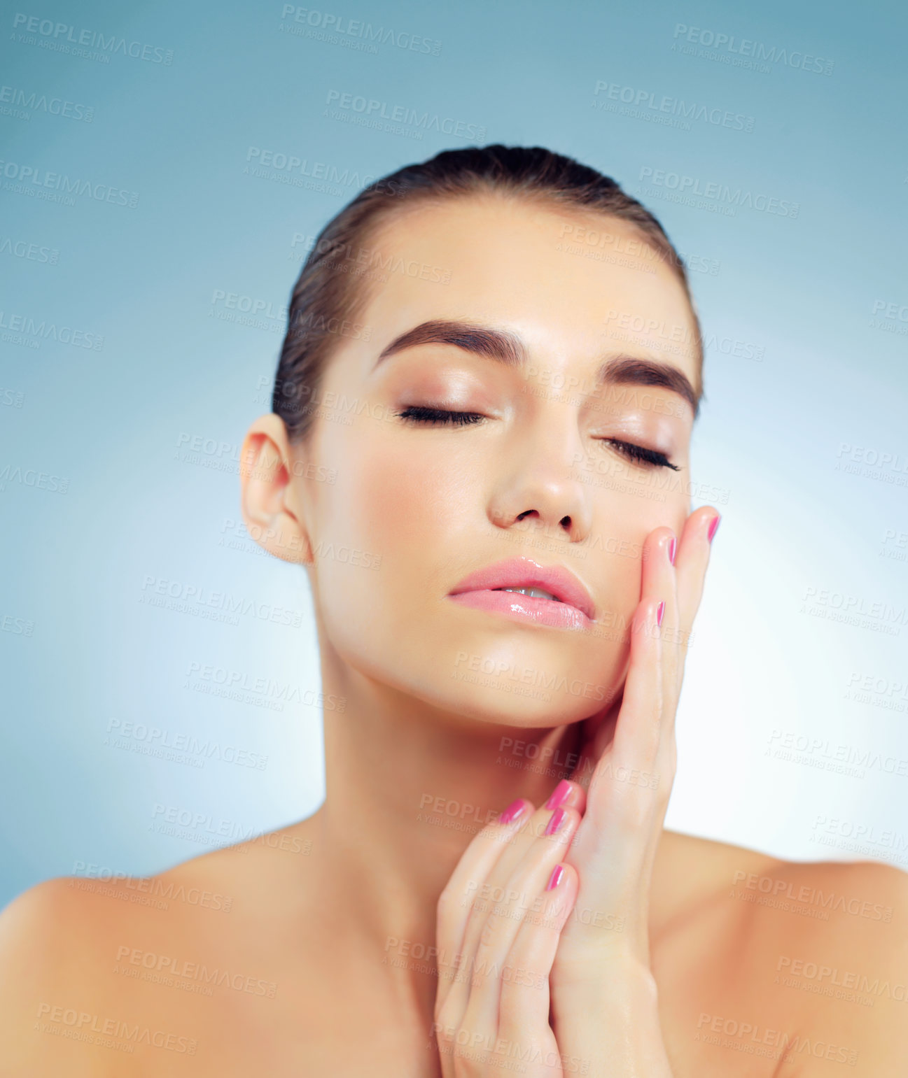 Buy stock photo Skincare, treatment and woman in studio, spa and wellness with cosmetics, shine and confident with glow. Blue background, beauty and results of dermatology, relax and proud of hydration and skin