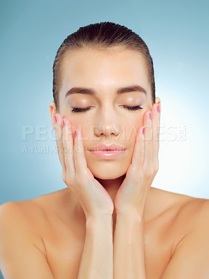 Buy stock photo Skincare, relax and woman in studio, glow and wellness with cosmetics, shine and treatment in spa. Blue background, beauty and results of dermatology, grooming and proud of hydration and skin