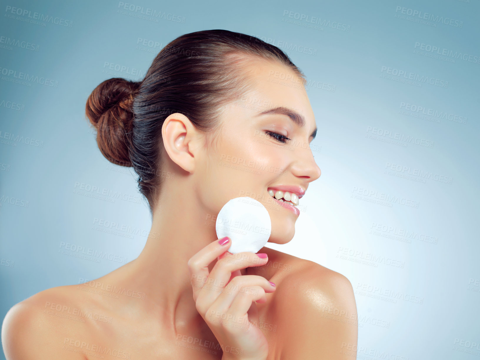 Buy stock photo Girl, studio and cotton pad for skincare or facial cleansing, beauty treatment and routine for skin tone with shine or glow. Woman, blue background and cosmetic product for makeup removal and wipe.