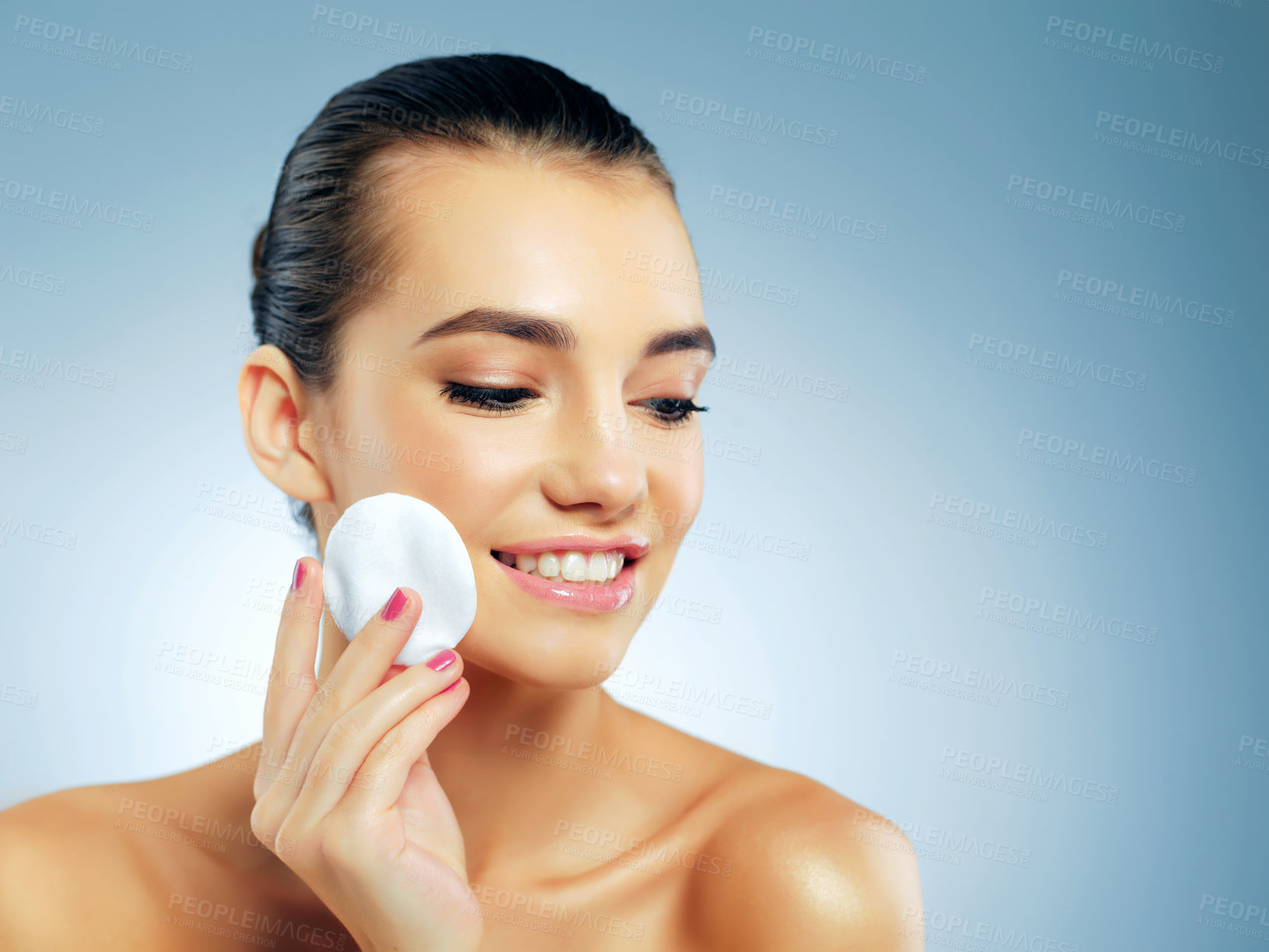 Buy stock photo Woman, studio and cotton pad for skincare or facial cleansing, beauty treatment and routine for skin tone with shine or glow. Girl, blue background and cosmetic product for makeup removal and wipe.