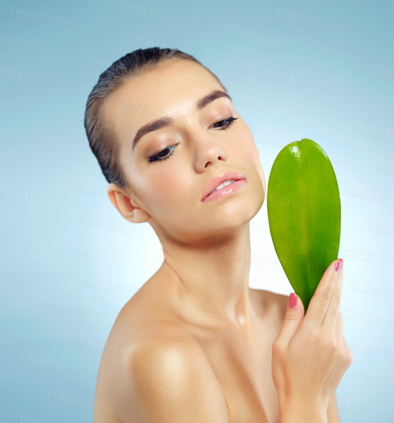 Buy stock photo Woman, thinking and leaf in studio for skincare or natural dermatology, organic treatment and ingredient for cosmetics. Girl, blue background and leave for skin, anti aging and hyperpigmentation.