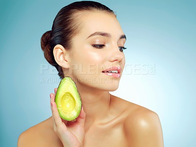 Buy stock photo Avocado, skincare and woman in studio with natural, organic and face routine with health. Beauty, wellness and female person with nutrition fruit for facial dermatology treatment by blue background.