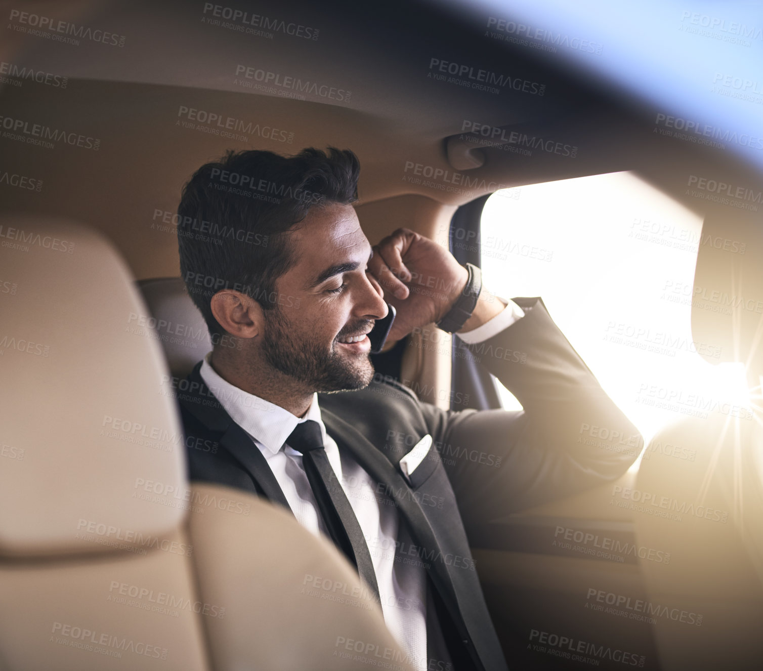 Buy stock photo Cropped shot of a handsome young businessman making a phonecall while on his morning commute to work