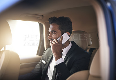 Buy stock photo Cropped shot of a handsome young businessman making a phonecall while on his morning commute to work
