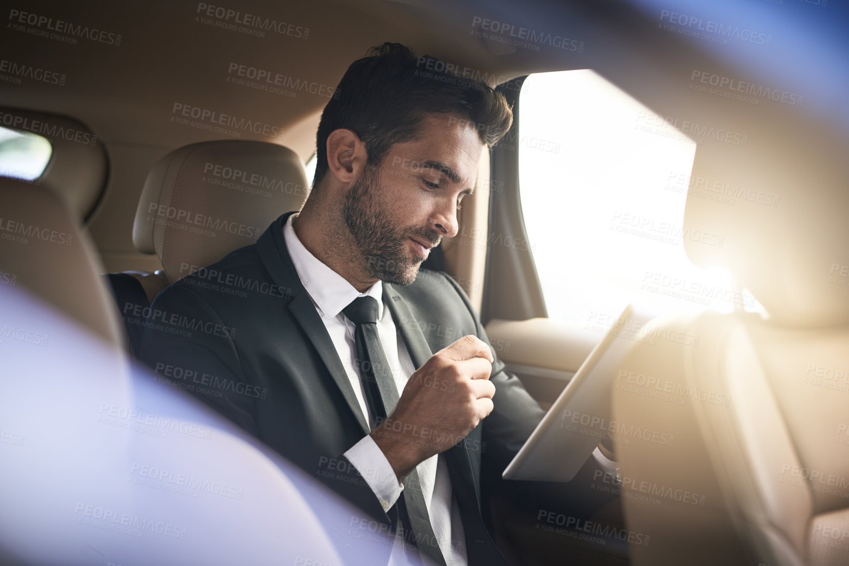 Buy stock photo Business man, passenger and tablet in transportation service with car, taxi or chauffer cab for travel or trip. Corporate investor reading of news on digital technology and drive to work or airport