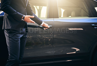 Buy stock photo Cropped shot of a well dressed and unrecognizable man opening a car door