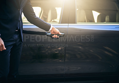Buy stock photo Cropped shot of a well dressed and unrecognizable man opening a car door