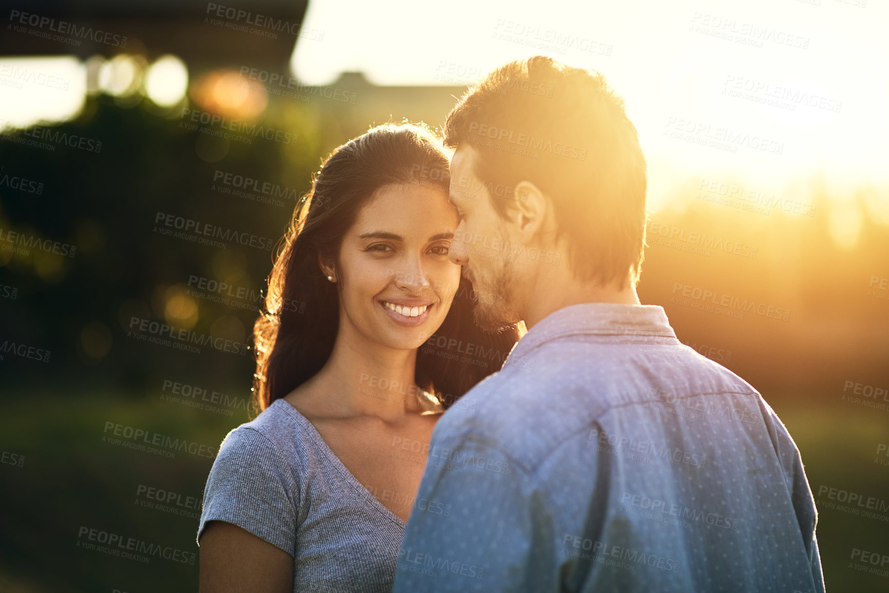Buy stock photo Portrait of a young woman bonding with her boyfriend outdoors