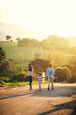 Buy stock photo Rearview shot of a family walking in the countryside