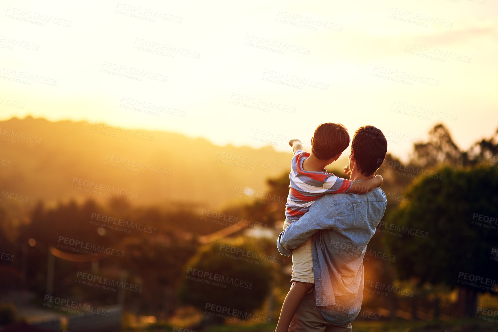 Buy stock photo Father, child and pointing to sunset in nature for travel, holiday or weekend getaway outdoors. Back of dad holding kid enjoying the future, sunrise or horizon for family bonding on mockup space
