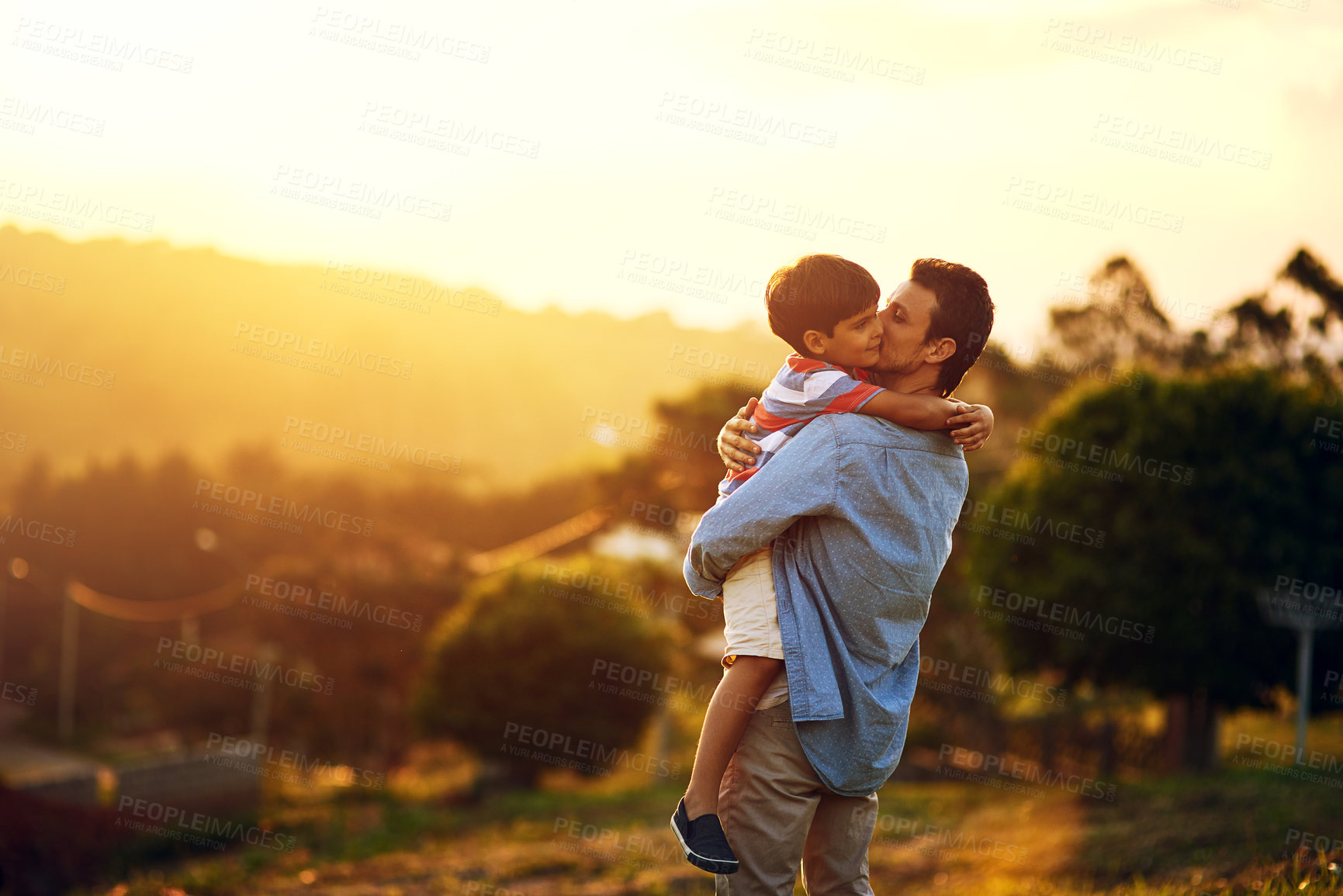 Buy stock photo Shot of a father and his little son bonding together outdoors