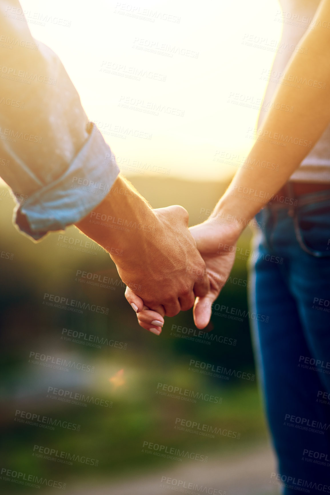 Buy stock photo Closeup shot of an unrecognizable couple holding hands outdoors