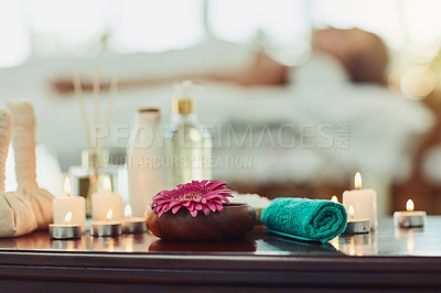 Buy stock photo Candles, flower and towel on table in spa for aromatherapy, treatment or wellness at luxury resort. Calm, peace and relax with still life objects in beauty salon for healing, massage or skincare