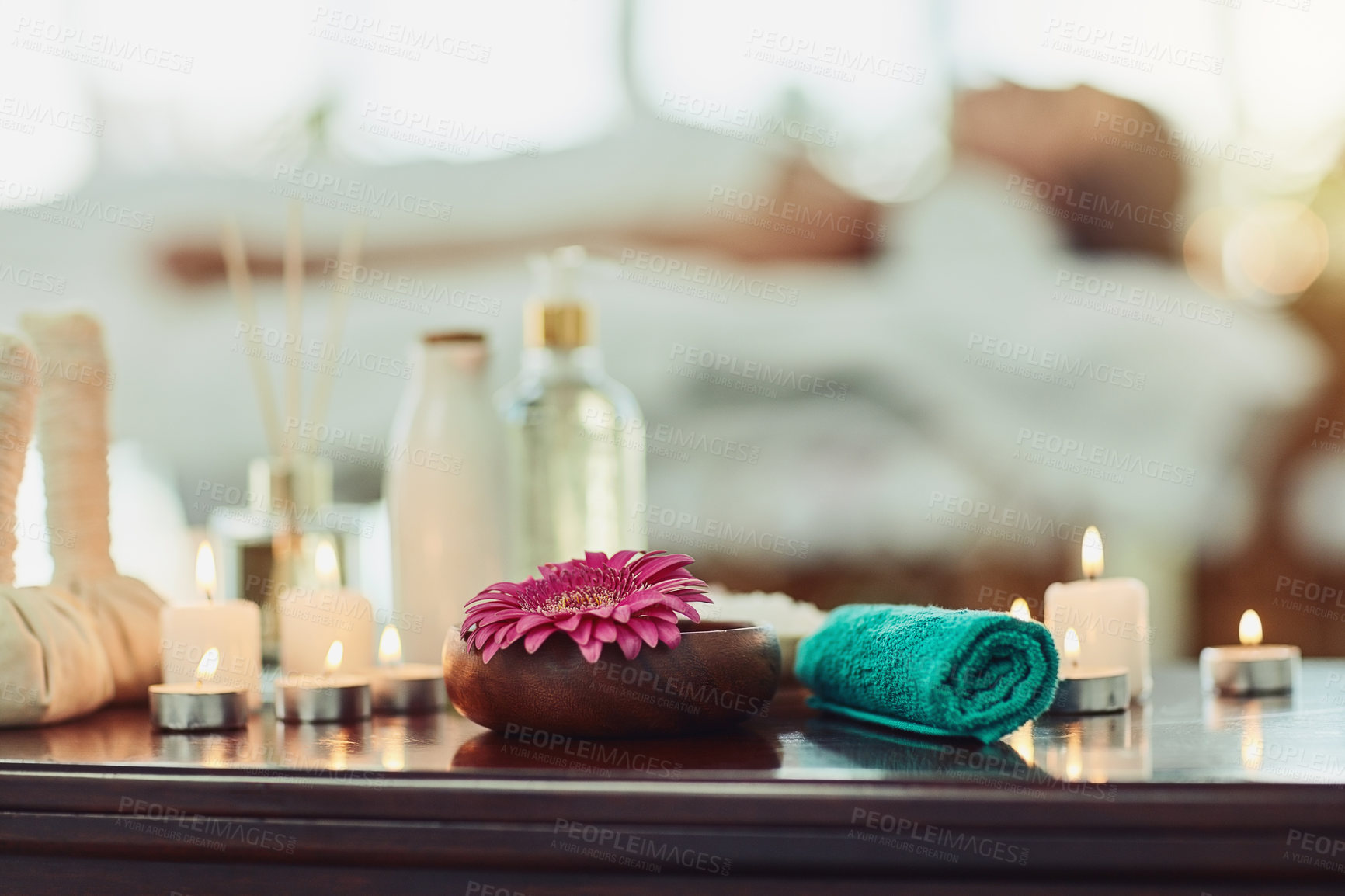 Buy stock photo Candles, flower and towel on table in spa for aromatherapy, treatment or wellness at luxury resort. Calm, peace and relax with still life objects in beauty salon for healing, massage or skincare