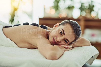 Buy stock photo Hot stone, portrait and relax with woman at spa for skincare therapy, zen and luxury treatment. Detox, holistic healing and salon with person at hotel for cosmetics, wellness center and massage