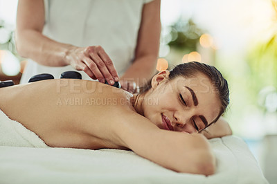 Buy stock photo Health, relax and woman getting a hot stone back massage at spa for luxury, calm and natural self care. Beauty, body care and tranquil female person sleeping while doing rock body treatment at salon.
