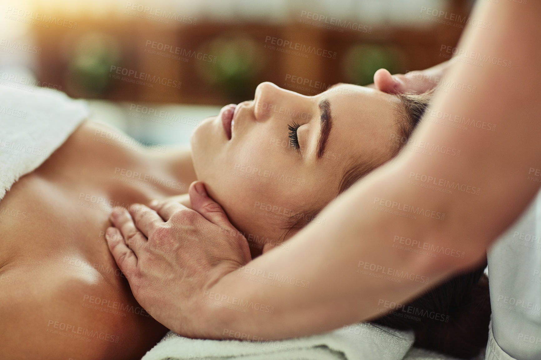 Buy stock photo Hands, massage and face of woman for relax, beauty and treatment for client on bed. Towel, spa or lymphatic drainage in salon by masseuse person, facial or stress relief for cosmetic therapy service