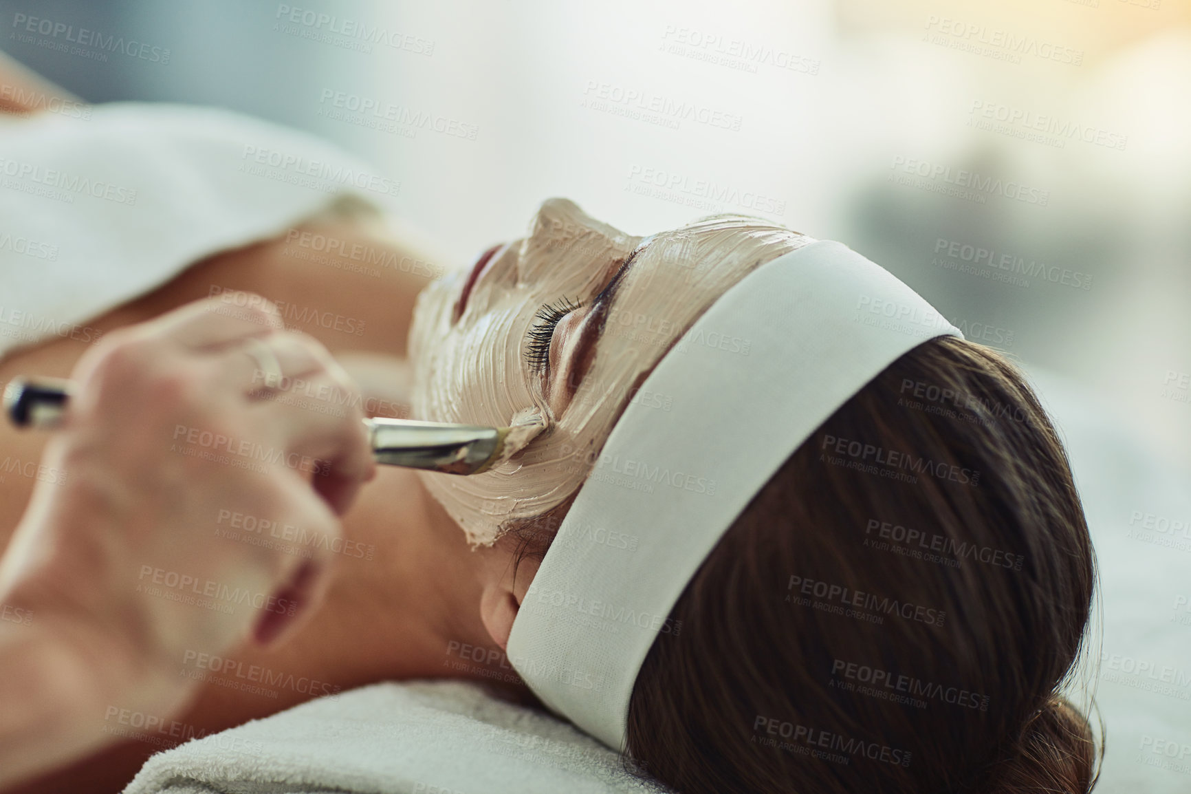 Buy stock photo Shot of an attractive young woman getting a facial at a beauty spa