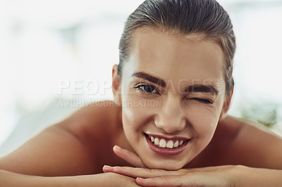 Buy stock photo Portrait, massage and wink with woman at spa for skincare therapy, zen and beauty treatment. Detox, holistic healing and salon with person at hotel resort for cosmetics, wellness center and pamper
