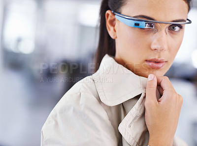 Buy stock photo Cropped shot of an attractive young businesswoman using smartglasses in her office