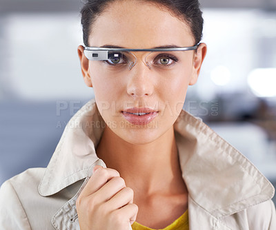 Buy stock photo Cropped portrait of an attractive young businesswoman using smartglasses in her office