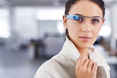 Buy stock photo Cropped portrait of an attractive young businesswoman using smartglasses in her office