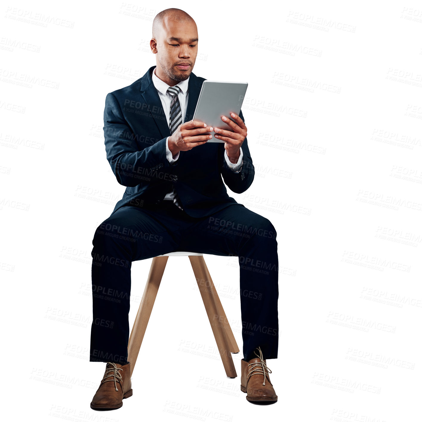 Buy stock photo Studio shot of a handsome young businessman using a tablet against a white background