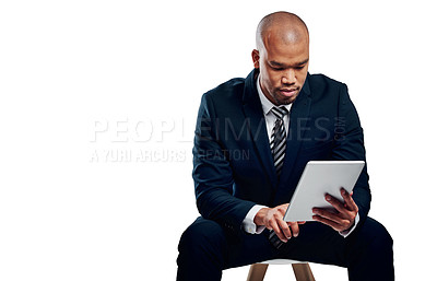 Buy stock photo Studio shot of a handsome young businessman using a tablet against a white background