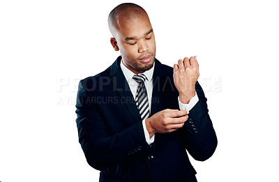 Buy stock photo Studio shot of a handsome young businessman fixing his sleeve against a white background