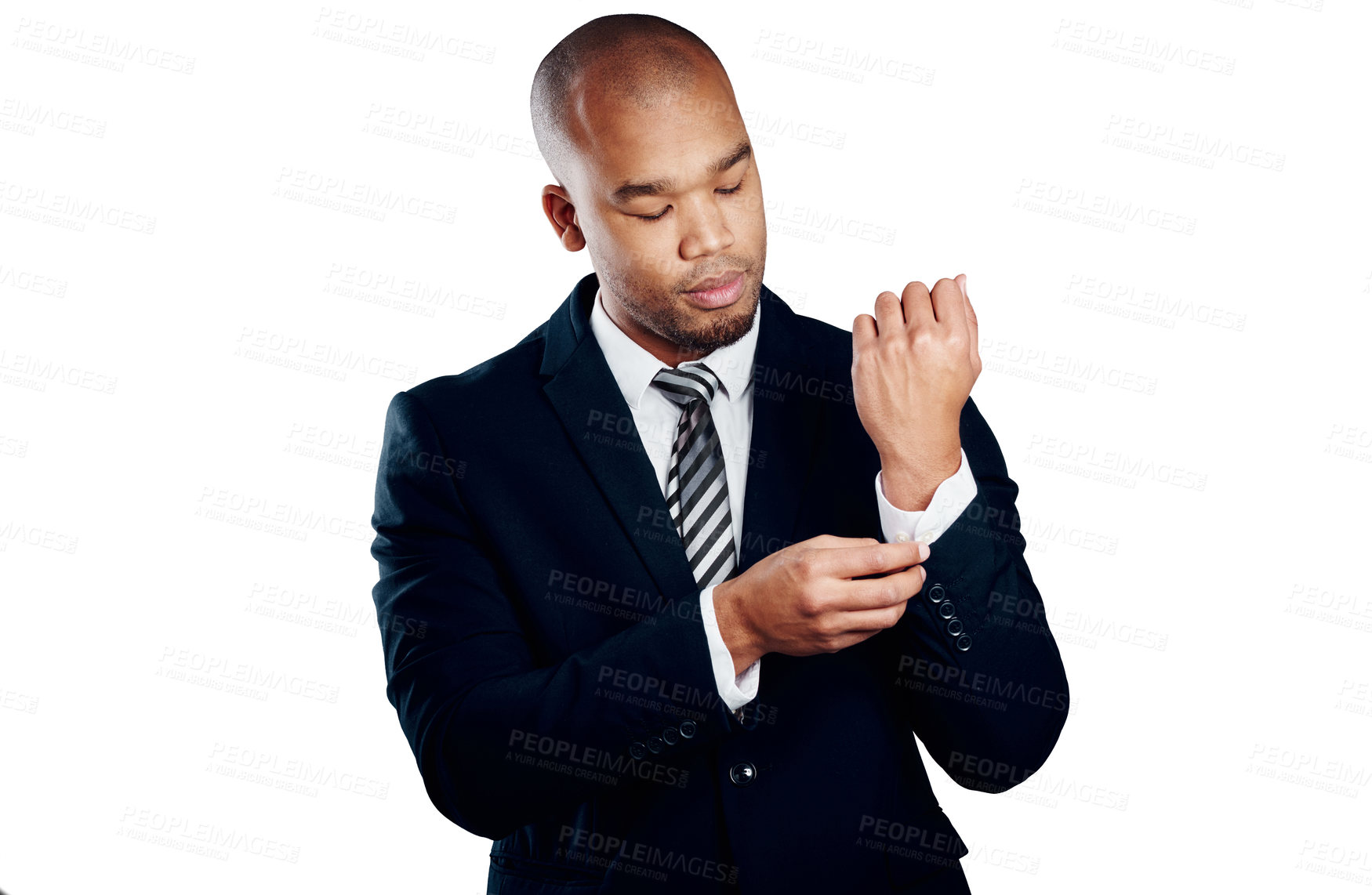 Buy stock photo Studio shot of a handsome young businessman fixing his sleeve against a white background