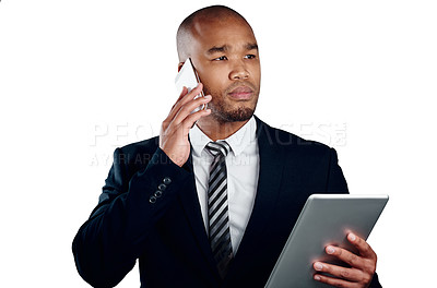 Buy stock photo Studio shot of a handsome young businessman on a call and using a tablet against a white background