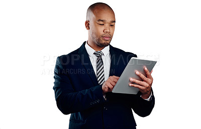 Buy stock photo Studio shot of a handsome young businessman using a tablet against a white background