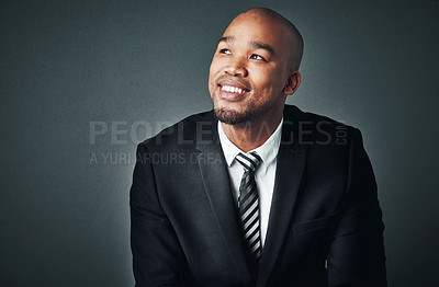 Buy stock photo Studio shot of a handsome young businessman posing against a gray background