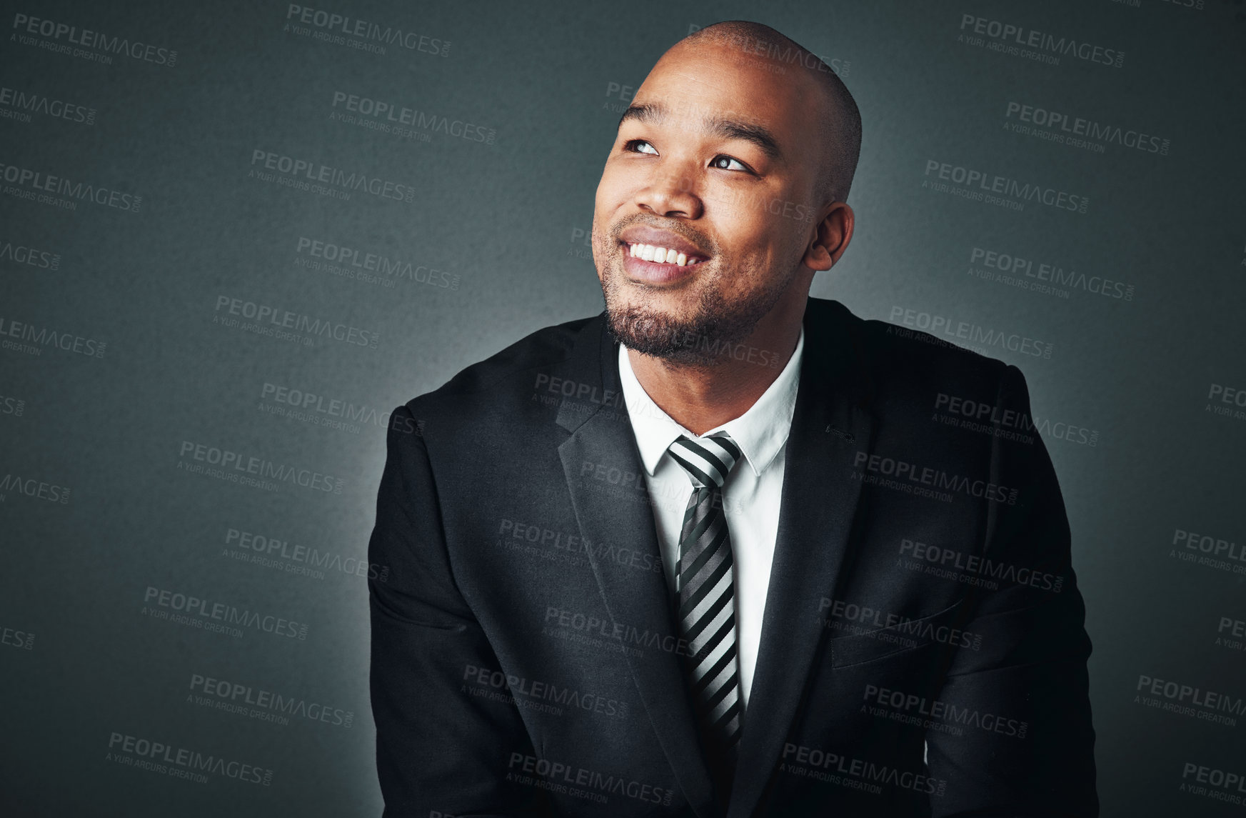 Buy stock photo Studio shot of a handsome young businessman posing against a gray background