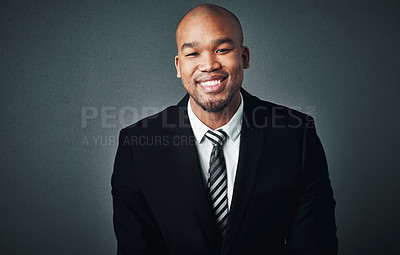 Buy stock photo Studio shot of a handsome young businessman posing against a gray background