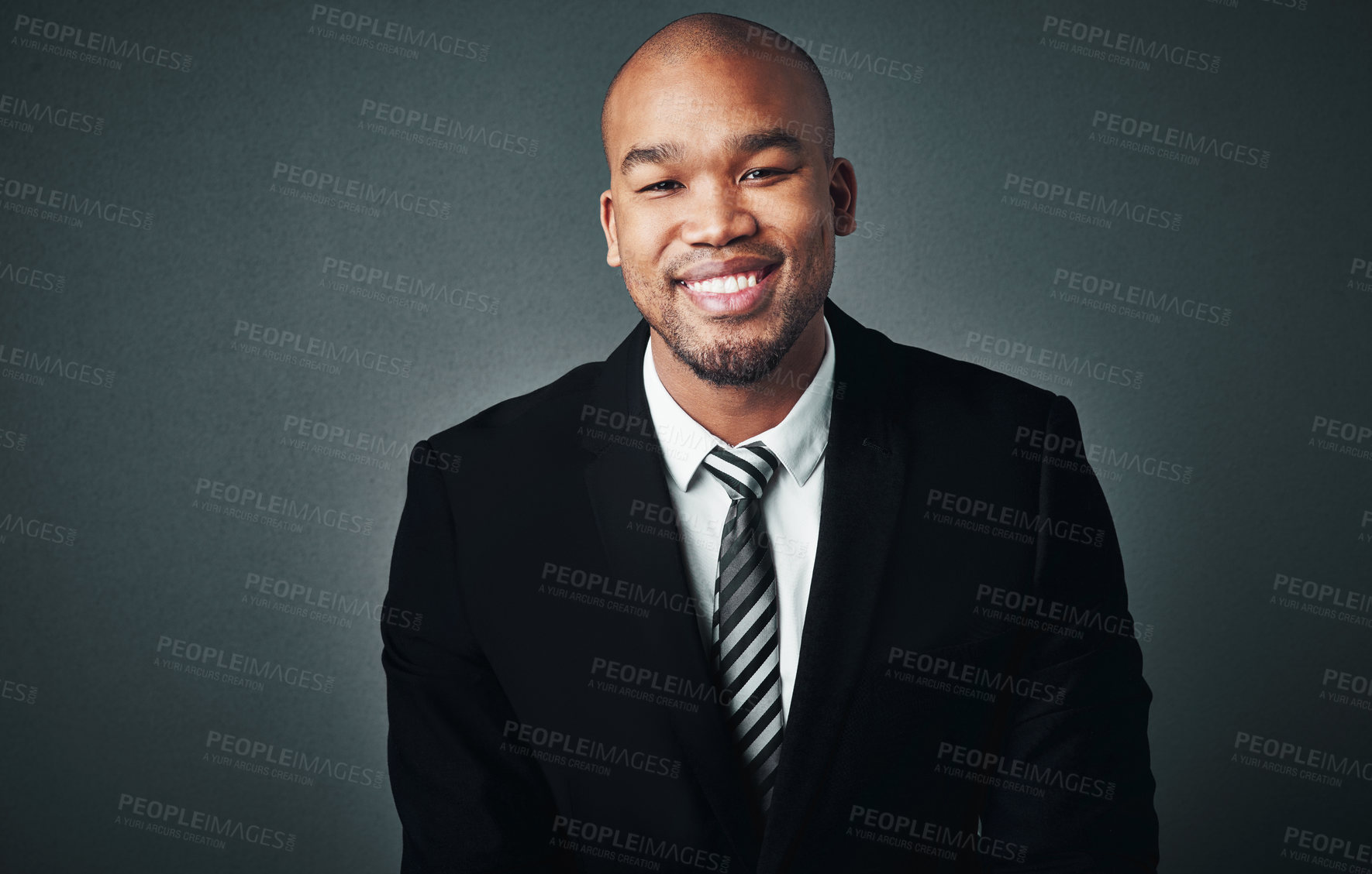 Buy stock photo Studio shot of a handsome young businessman posing against a gray background